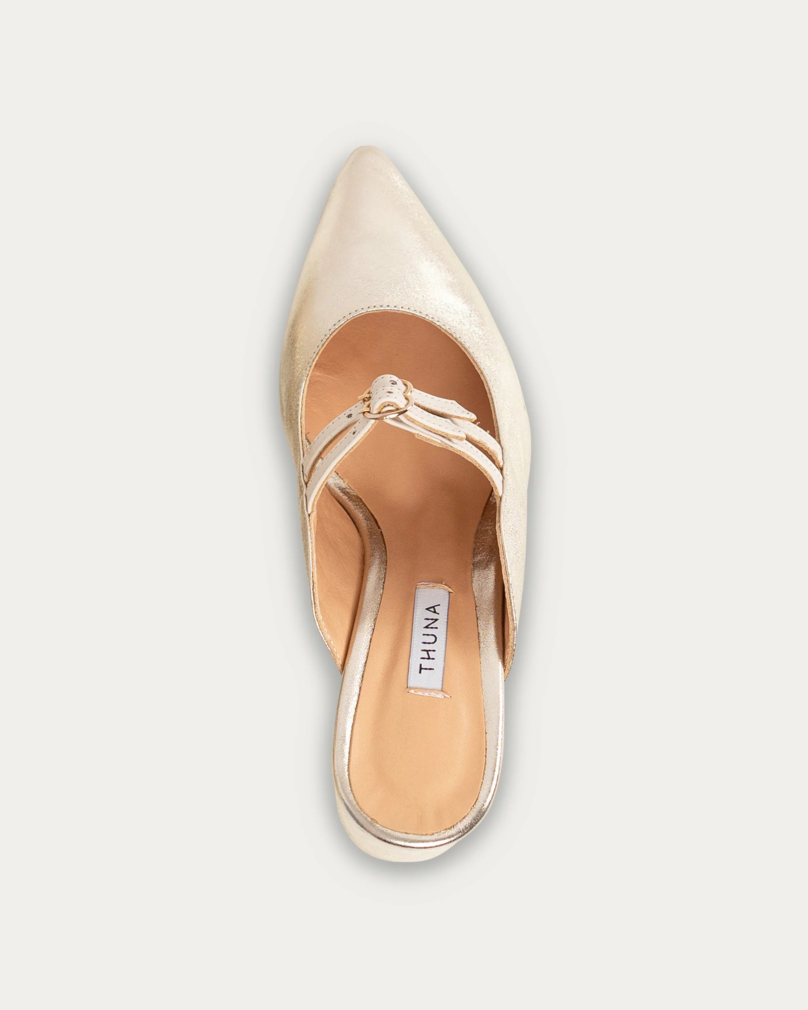 Gold pointed-toe mule with strap detail, handmade for modern women's everyday style.